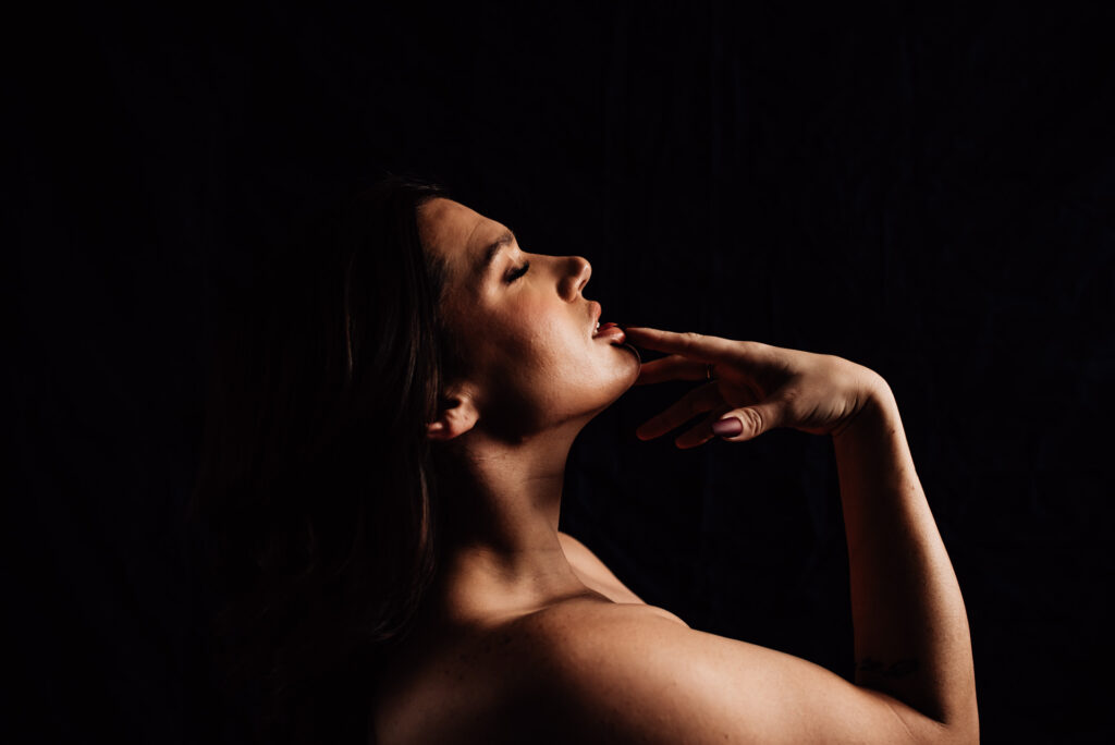 woman touching lip for intimate portraits ottawa with Lindsey M Boudoir