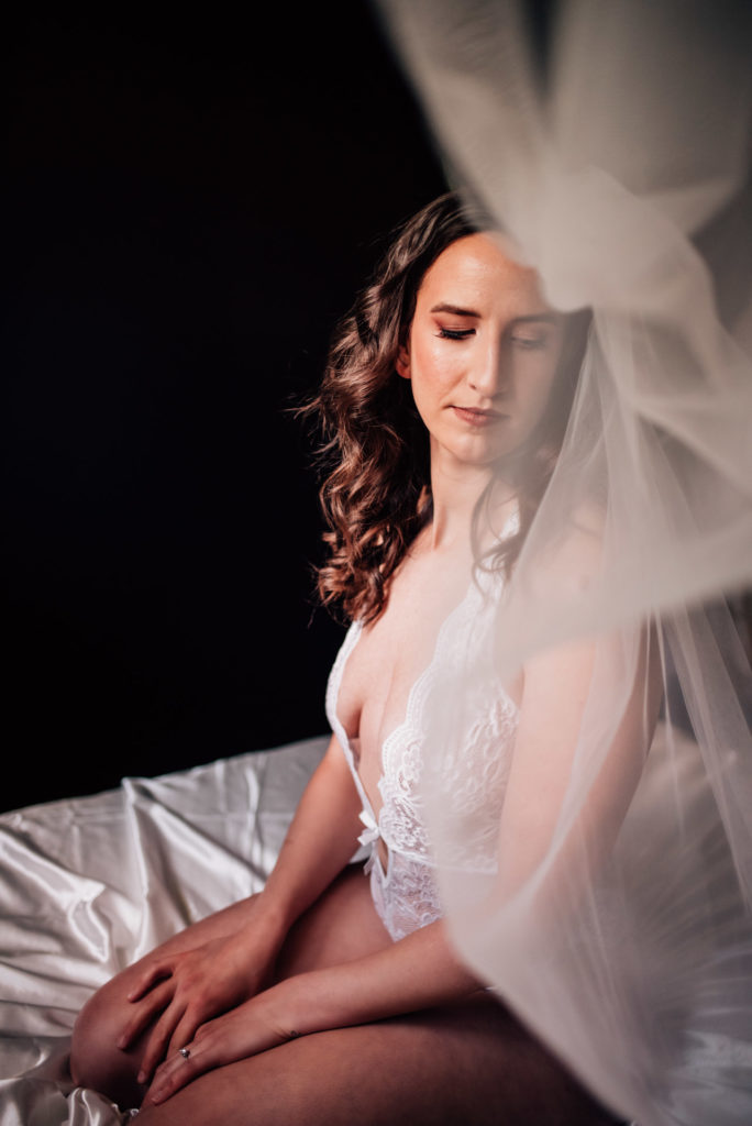 Ottawa bride in a plunging lace bodysuit for boudoir session