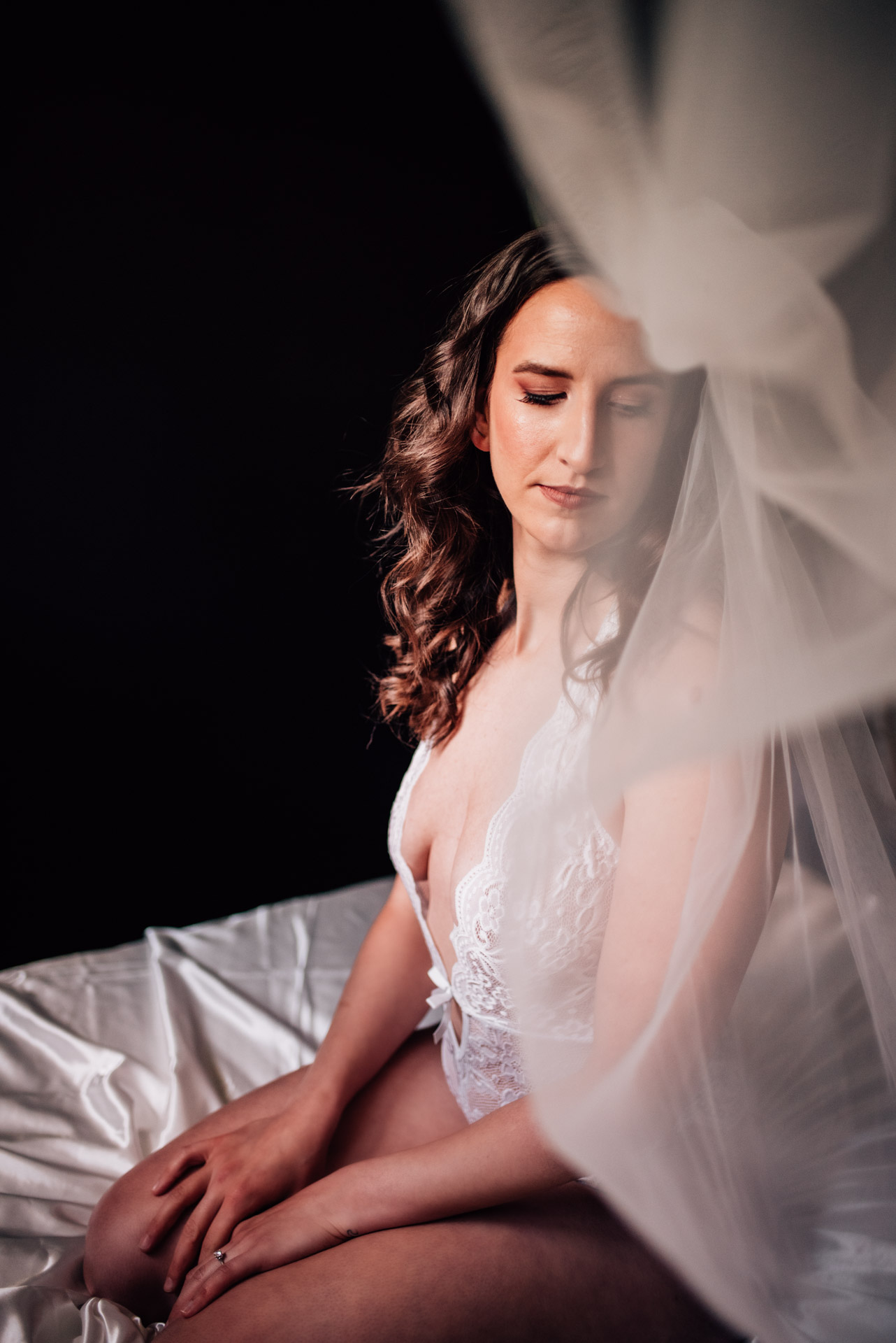 bride wearing veil for boudoir album