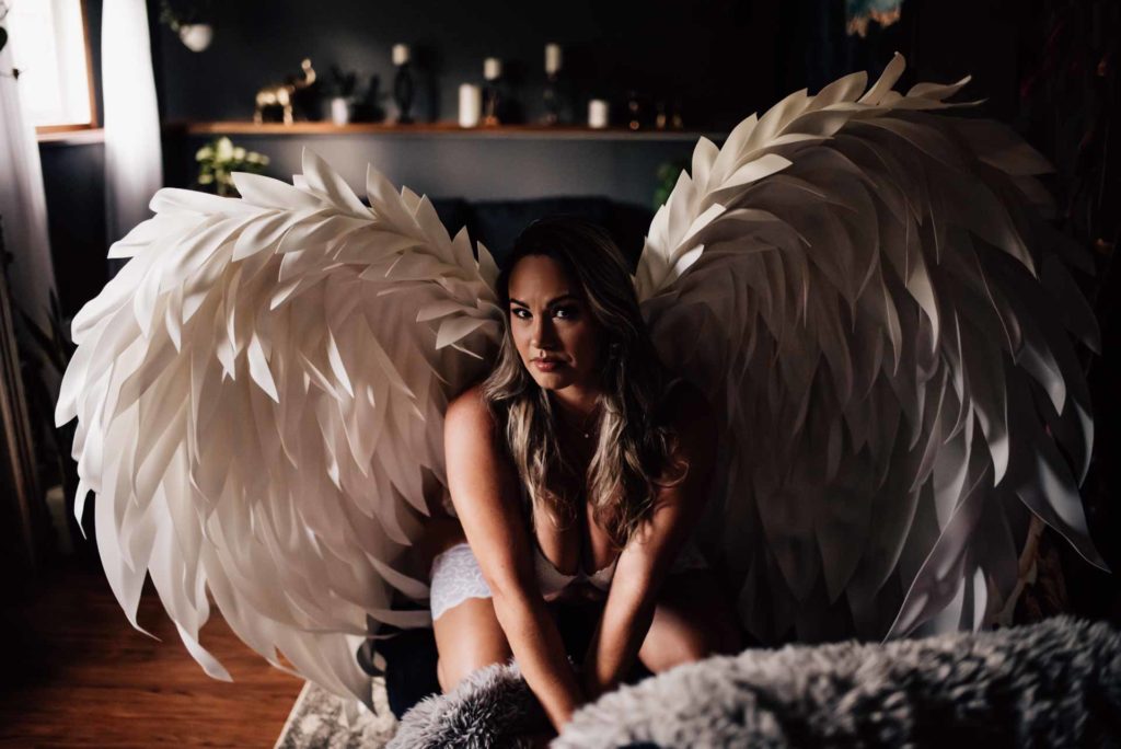 woman in angel wings for ottawa boudoir photographer