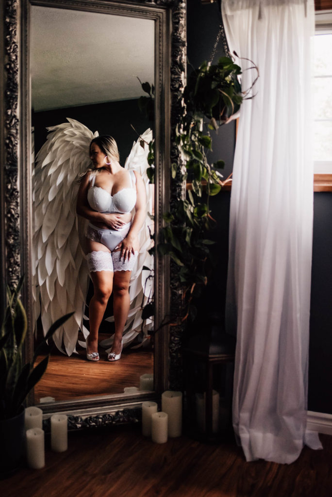 woman posing for boudoir session in angel wings