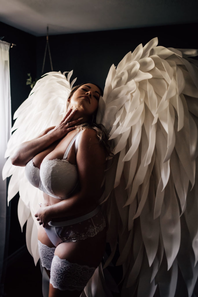 woman in white lingerie and angel wings for ottawa boudoir photography session