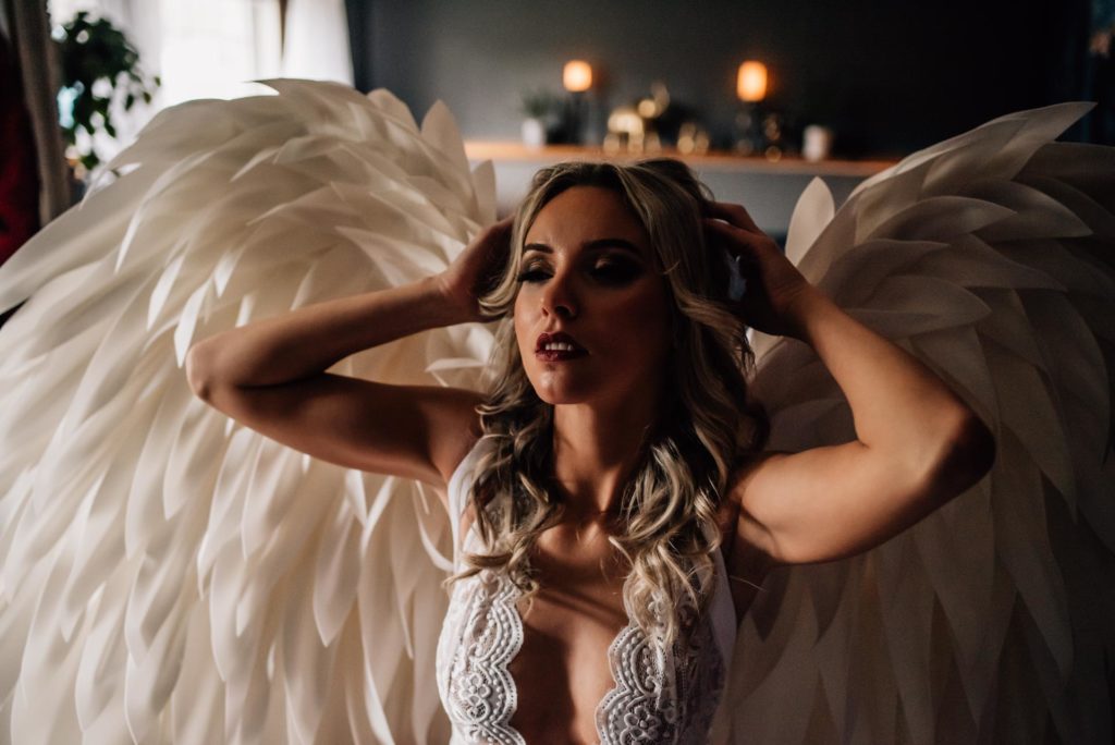 woman wearing angel wings for boudoir session