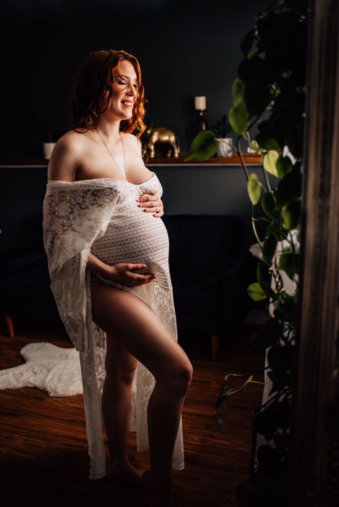 pregnant woman wearing boho style maternity dress for Ottawa boudoir session