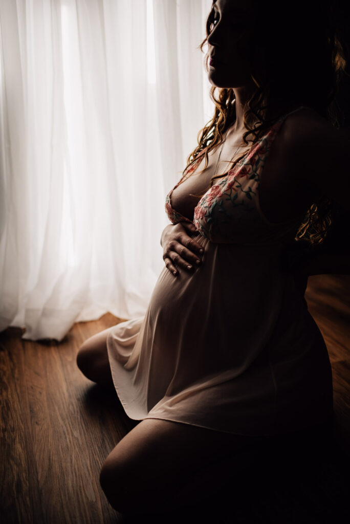 expecting mother wearing babydoll outfit for maternity boudoir session