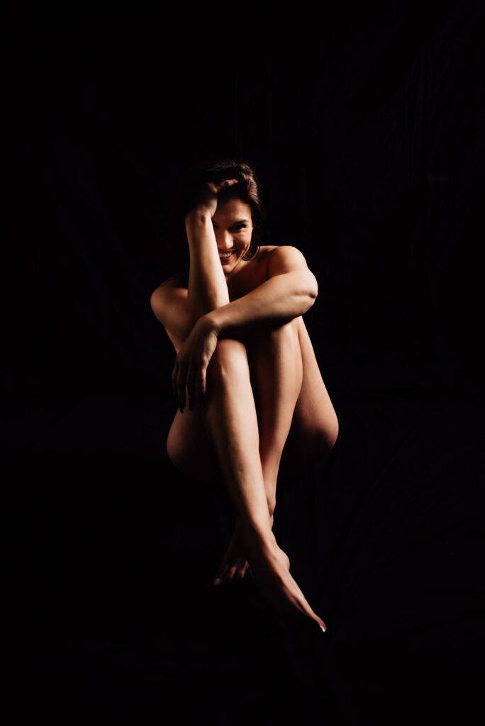 woman laughing during intimate portraits ottawa boudoir session